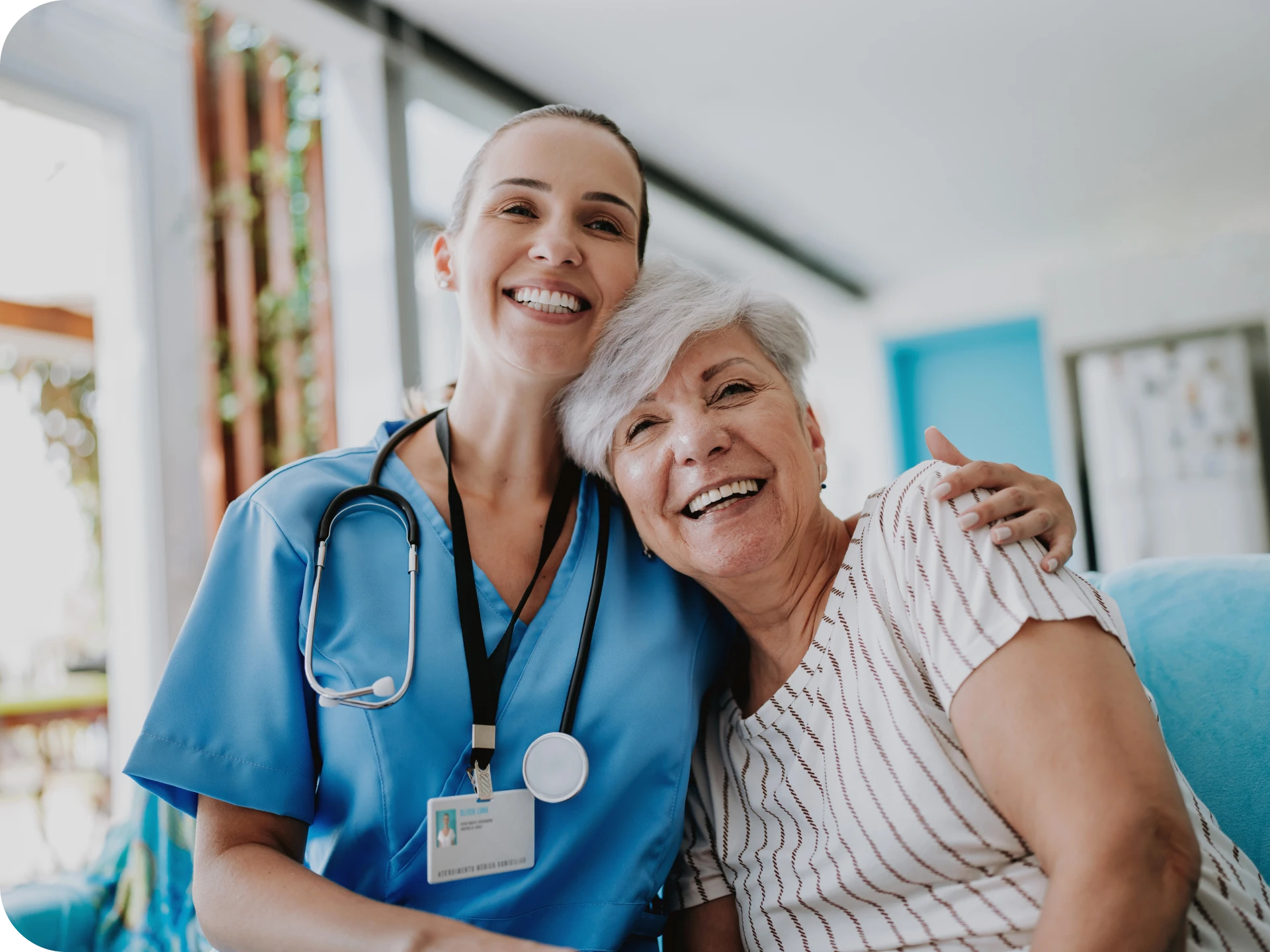 Nurse and elderly woman smiling together.