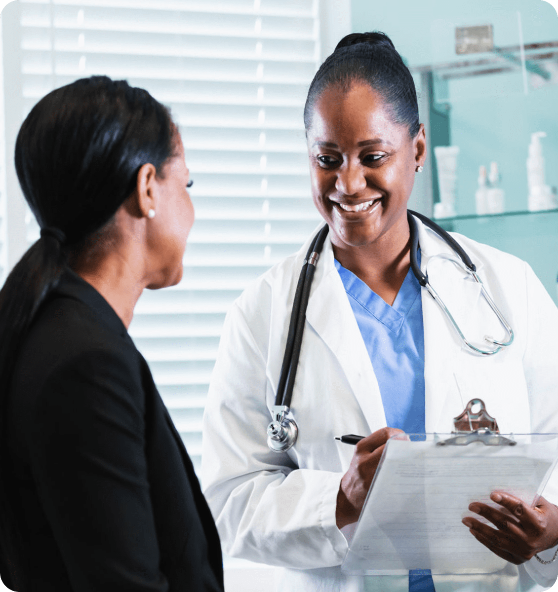 Doctor consulting with a patient, holding clipboard.